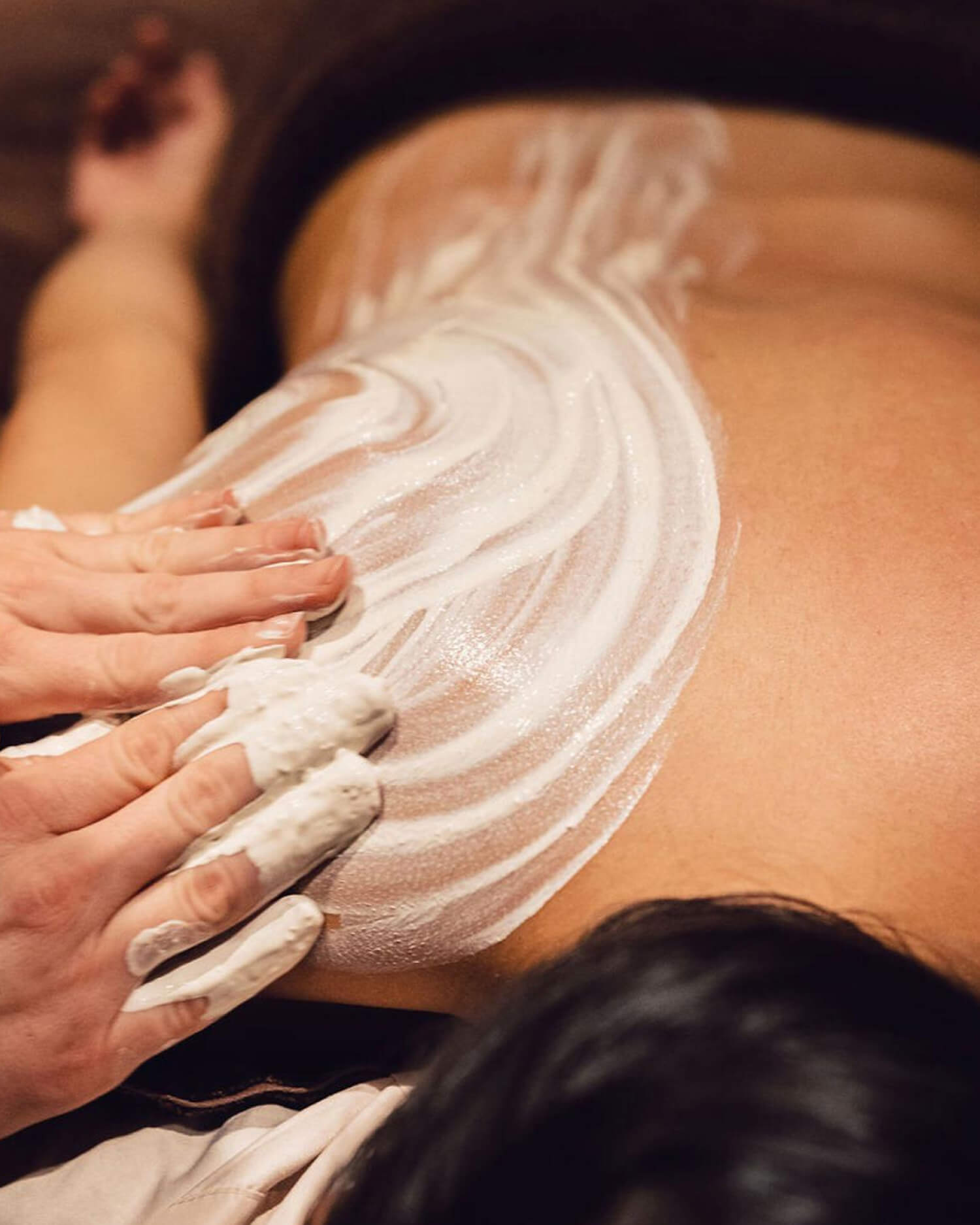 A woman laying on the massage table.