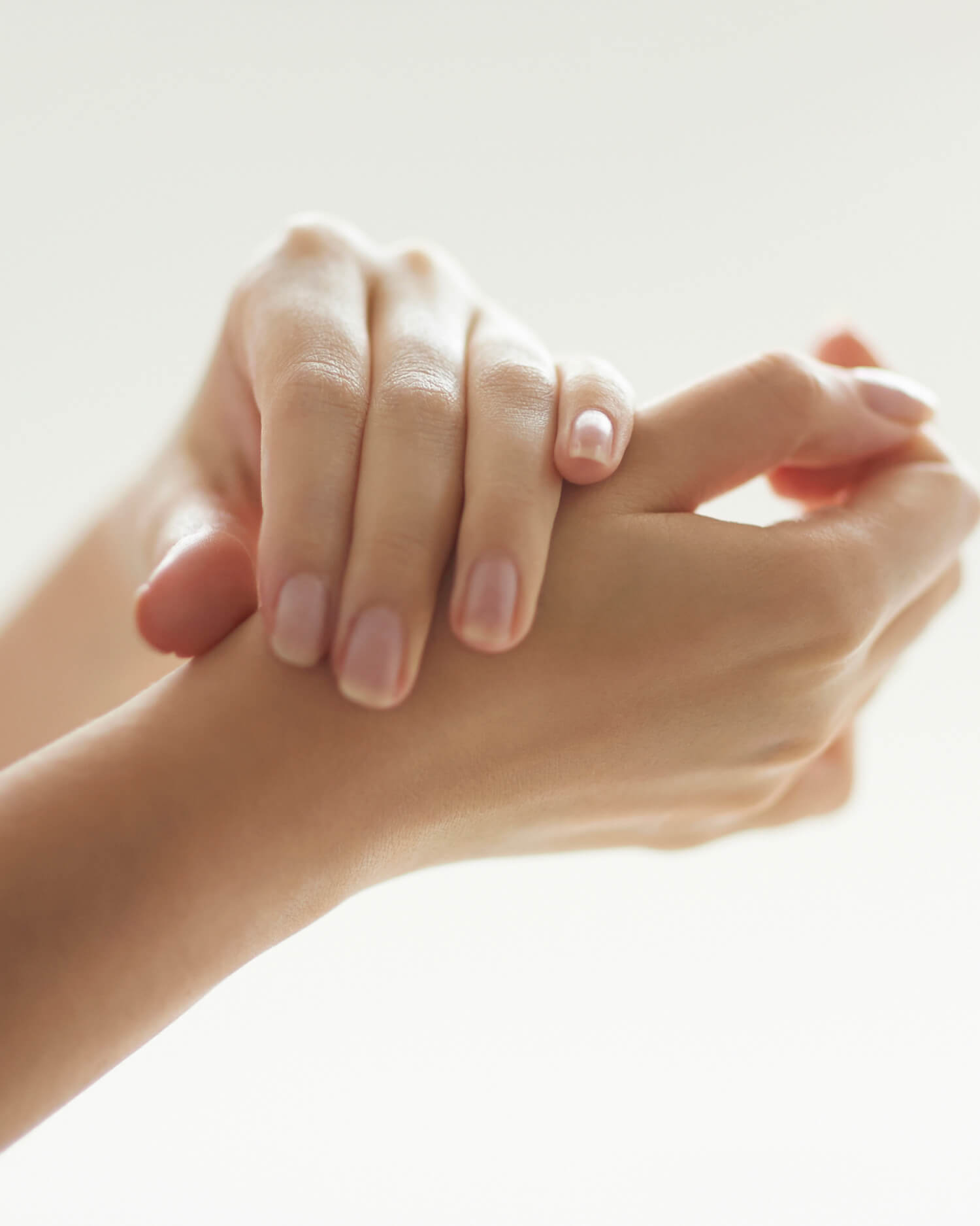 Woman receiving manicure treatment.