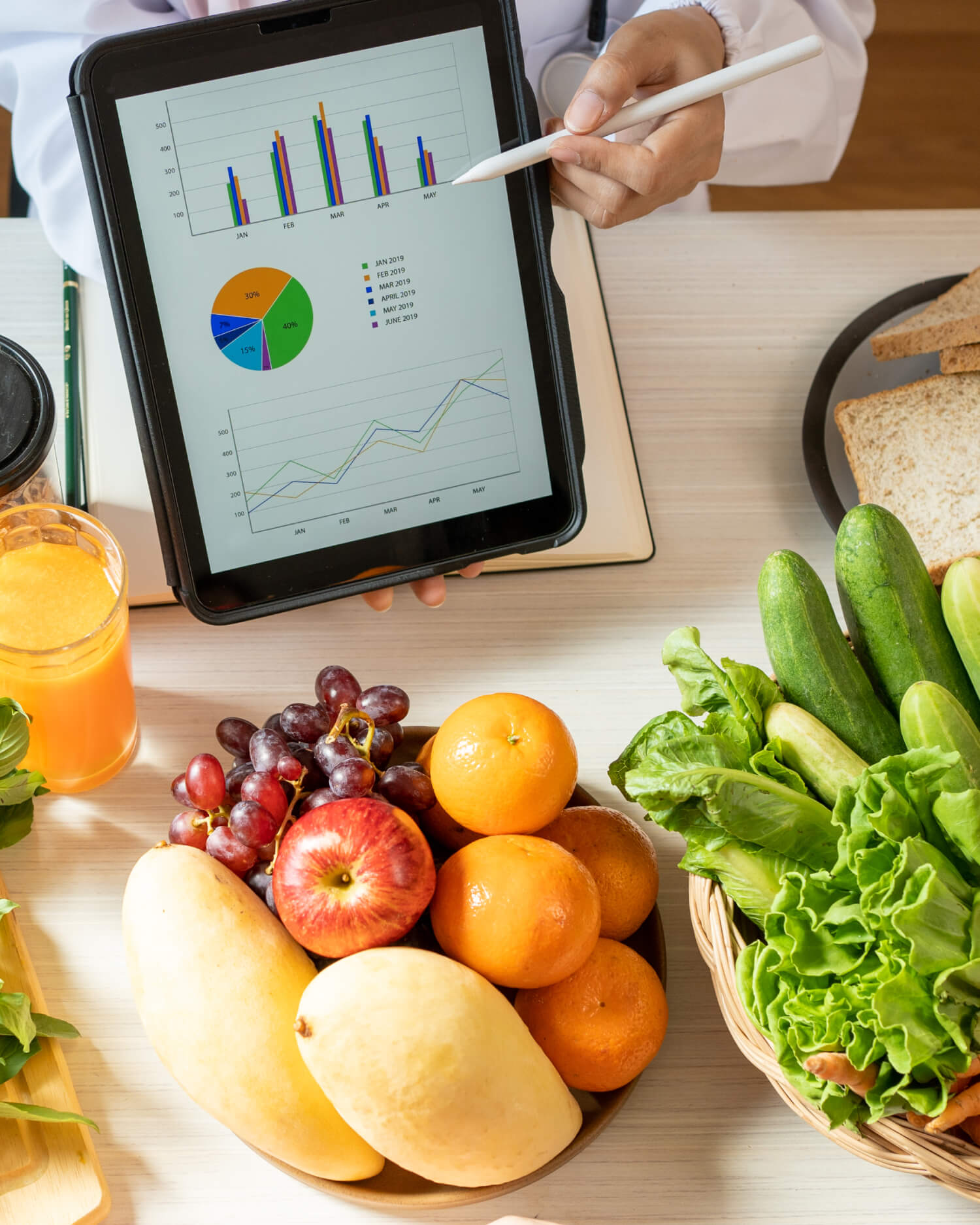 A dietician showing a graph of macronutrients in assorted vegetables to a nutrition patient.