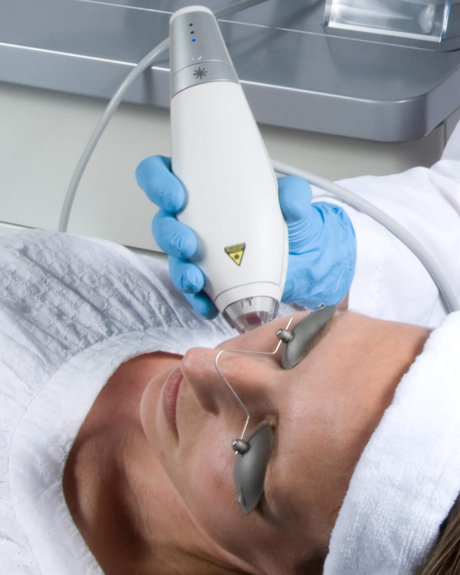 Woman receiving Clear + Brilliant® gentle and effective laser facial treatment.