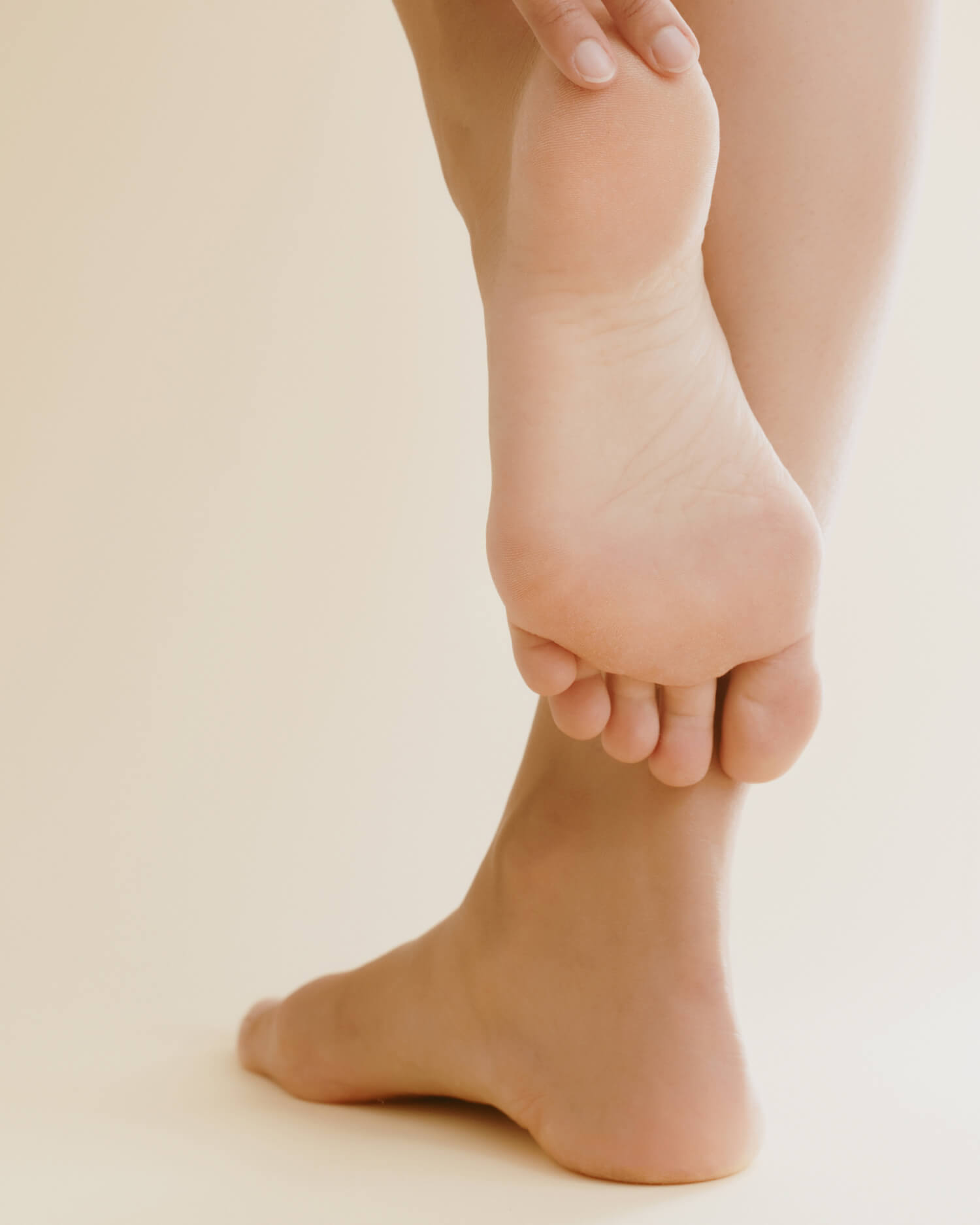 A woman rubbing her newly pedicured feet.