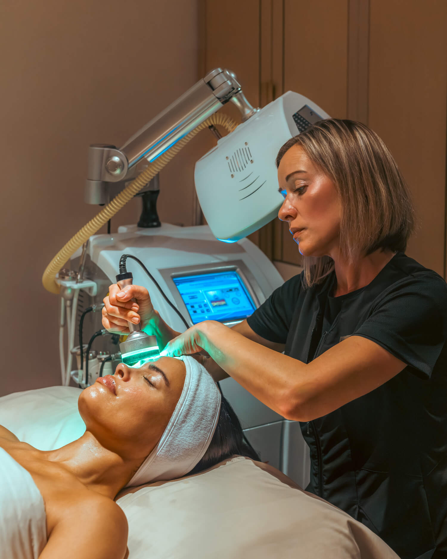 A woman receiving an oxygen facial.