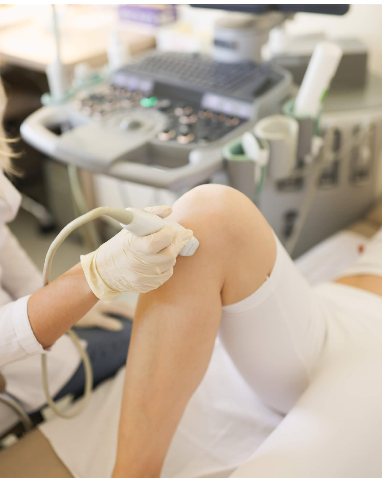 Woman receiving a Vascular Ultrasound treatment on her legs.