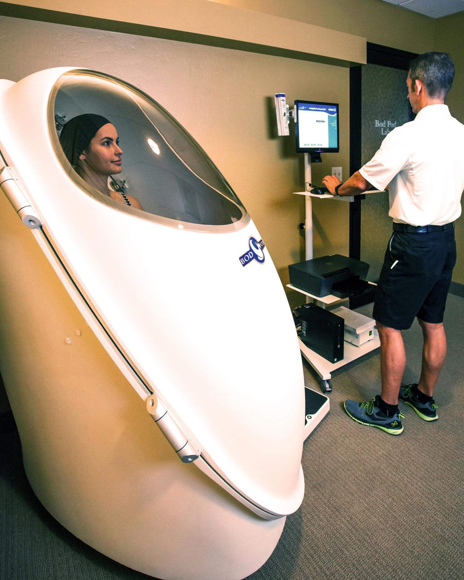 A woman getting a bodpod assessment